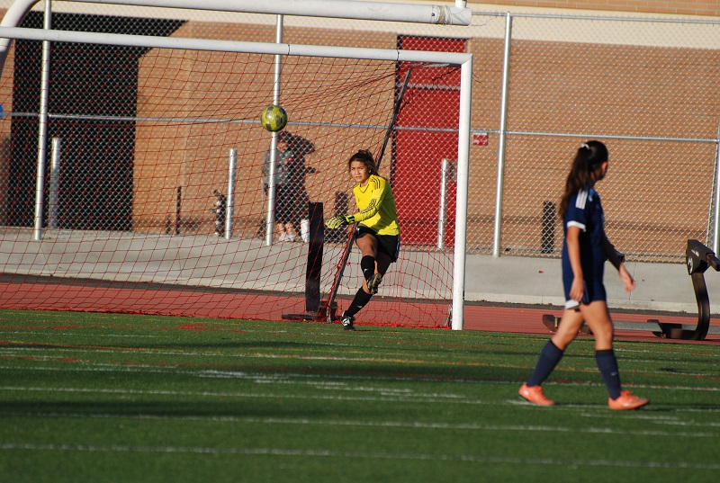 Junior goalkeeper Ayanna Melin (1) boots a goal kick